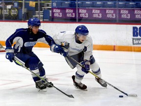 Sudbury Wolves defenceman Nathan Ribau, right, handles the puck while under pressure from forward Alex Assadourian during a scrimmage on the opening day of main training camp at Sudbury Community Arena in Sudbury, Ontario on Wednesday, September 1, 2021.