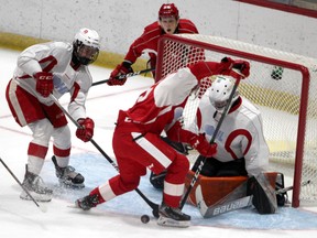 Team Red Alex Johnston presses Team White goalie Charlie Schenkel while Owen Parsons (18) watches during first-period Soo Greyhounds Red and White Game action at GFL Memorial Gardens on Friday, Sept. 3, 2021 in Sault Ste. Marie, Ont. (BRIAN KELLY/THE SAULT STAR/POSTMEDIA NETWORK)