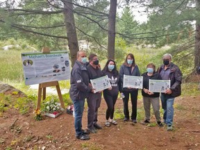 North Bay-Mattawa Conservation Authority chair Dave Mendicino, left, Don Seguin, Samantha Seguin-Gauthier, Michelle Seguin, and Ruth and Mark Gauthier mark the dedication of a new boardwalk, Friday, at Laurier Woods Conservation Area in memory of Michael Gauthier, who died in 2018. Submitted Photo