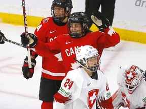 Team Canada's Rebecca Johnston scores on Team Switzerland's goalie Andrea Braendli in third period action during the 2021 IIHF Women’s World Championship semi-finals at the Winsport arena in Calgary on Monday, August 30, 2021.