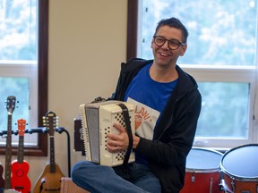 Pastor Josh Friend of the Evergreen Community Church plays an accordion at Alani, an instrument library he runs out of the church, on September 3, 2021. Scott McLean/Fort McMurray Today/Postmedia Network