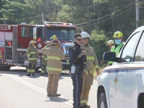 An OPP officer talks with firefighters from the Whitewater Region Fire Department and a member of the Renfrew County Paramedic Service at the scene of a motorcycle crash on Beachburg Road near Zion Line Wednesday morning, Sept. 1. Anthony Dixon