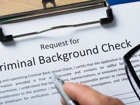 Hand Filling Criminal Background Check Application Form