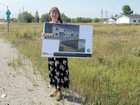 Susan Nelson, executive director of Ininew Friendship Centre, holds up a drawing of their proposed 16-unit housing complex they hope to build across from the water tower in Cochrane. SUBMITTED PHOTO