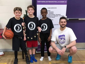 Northern Lights Basketball Academy head of operations Kyle Beers, right, poses for a photo with three participants in the NLBA Christmas three-on-three event in December 2019. Beers plans to launch the Northern Lights Basketball Academy 3X3 League on Sept. 18, 2021.