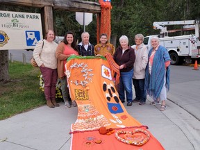 Creative reconciliation 
Amanda Tanner and community members with their creative reconciliation installation - a visual honouring or acknowledgement, for residential school survivors. Crestview Electric LTD helped hang the two long pieces of orange-toned fibre art, on the George Lane Memorial Park entrance on Sept. 1.