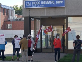 Members of Unifor held a rally in front of Ross Romano's downtown office on Monday afternoon.