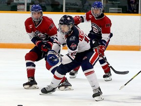 Michael Campbell (7) and Alexander Dillon (44) of the Greater Sudbury Cubs defend while French River Rapids forward Dominik Godin (10) looks to break free for a scoring chance during NOJHL pre-season action at Gerry McCrory Countryside Sports Complex in Sudbury, Ontario on Sunday, September 12, 2021.