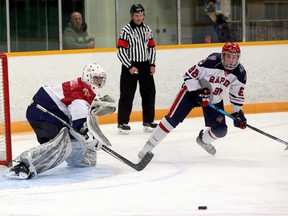 Joel Rainville (1) of the Greater Sudbury Cubs and Chase Thompson (92) of the French River Rapids keep their eyes on a loose puck after a Rapids scoring chance during NOJHL pre-season action at Gerry McCrory Countryside Sports Complex in Sudbury, Ontario on Sunday, September 12, 2021.