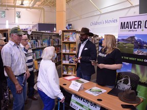 Maverick Party candidate Tariq Elnaga can be seen unmasked, speaking with others who at the Coffee with the Candidates event at the Airdrie Public Library on September 8, 2020. Riley Cassidy/Airdrie Echo