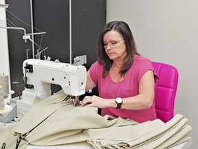 Julie Gohm, co-owner of The Original Bug Shirt Company in Powassan, applies the finishing touches to another bug shirt. Gohm is looking for skilled, qualified sewers to accommodate the company's current growth, which is expected to continue. Kathie Hogan Photo