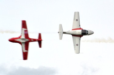 Because of some cloud cover, the Snowbirds pilots, all active members of the Royal Canadian Airforce, performed a mix of high and low-flying stunts, including some close, midair passes like this one. Galen Simmons/The Beacon Herald/Postmedia Network