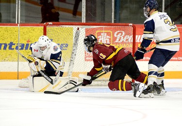 Timmins Rock forward Justin Charette managed to get off a shot on Kirkland Lake goalie Zachary Reddy on this play despite being pulled down by Gold Miners defender Spencer Jones. Reddy made the save, but it wouldn’t matter as the Rock went on to post a 7-3 victory over the visitors in the 2021-22 NOJHL regular season opener for both squads. THOMAS PERRY/THE DAILY PRESS