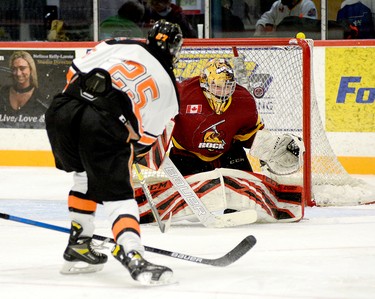Timmins Rock goalie Gavin McCarthy deflects a shot off the stick of Hearst Lumberjacks forward William Neeld up and over the crossbar during the second period of Sunday afternoon’s NOJHL game at the McIntyre Arena. McCarthy backstopped the Rock to a 2-1 overtime victory, as they improved to 2-0-0-0 on the young season. THOMAS PERRY/THE DAILY PRESS