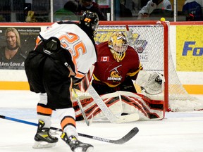 Timmins Rock goalie Gavin McCarthy deflects a shot off the stick of Hearst Lumberjacks forward William Neeld up and over the crossbar during the second period of Sunday afternoon’s NOJHL game at the McIntyre Arena. McCarthy backstopped the Rock to a 2-1 overtime victory, as they improved to 2-0-0-0 on the young season. THOMAS PERRY/THE DAILY PRESS