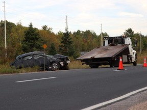 A tow truck pulls a vehicle out of the median on Highway 11, just north of Highview Golf Course, Monday afternoon. The lone driver suffered minor injuries in the single-vehicle collision. Michael Lee/The Nugget