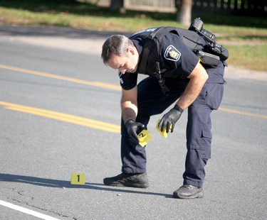 Sault Ste. Marie Police Service investigate a shooting incident that left a man dead and a police officer seriously injured near 696 Pine St., in Sault Ste. Marie, Ont., on Sunday, Sept. 19, 2021. (BRIAN KELLY/THE SAULT STAR/POSTMEDIA NETWORK)