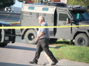 Special Investigations Unit investigates a shooting incident that left a man dead and a police officer seriously injured near 696 Pine St., in Sault Ste. Marie, Sunday. (BRIAN KELLY/THE SAULT STAR/POSTMEDIA NETWORK)