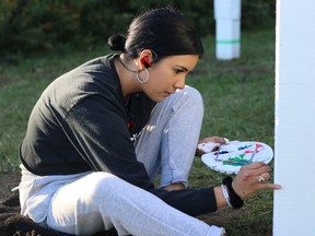 Sarah Rodrique works on the Inuit peace pole. An unveiling ceremony will be held at noon on Tuesday, the International Day of Peace, at the Schumacher Lions Club Park, behind the McIntyre Arena. DARIYA BAIGUZHIYEVA/LOCAL JOURNALISM INITIATIVE