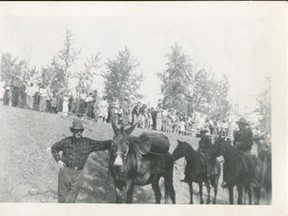 1978.932.018 – Information associated with this photograph of Baldy Red (George Yeoman) and his unnamed mule (note what appears to be a keg strapped to its side) and many other celebrants, suggests it was taken at the time of the opening of the (old) Smoky River Bridge southeast of Tangent in 1949/50, since replaced. On further investigation, the timing of the bridge completion and Baldy’s and mule’s attendance is unlikely, as Baldy, according to two divergent sources, was no longer willing with us at the time.