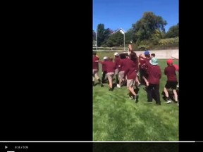 A frame from a video shows students with arms raised in the Nazi salute.