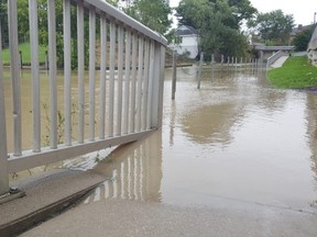 A flooded sidewalk is shown along the Thames River in downtown Chatham on Thursday. (Trevor Terfloth/The Daily News)