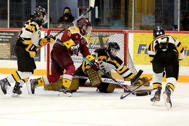 New Liskeard Cubs goalie Brett Ruddy reaches down with his catching glove to smother the puck before Timmins Rock forward Ryan Armitage can pounce on the rebound as teammates Craig Ross, left, and Nolan Ouelette look on during the first period of Saturday’s Great North U18 League exhibition contest at the McIntyre Arena. The two sides skated to a 1-1 draw. THOMAS PERRY/THE DAILY PRESS