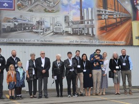 The Ault family stood below the new mural that shows the legacy of Ault Foods and how the company evolved on Friday September 24, 2021 in Winchester, Ont. Shawna O'Neill/Cornwall Standard-Freeholder/Postmedia Network