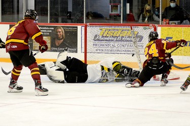 Timmins Rock forward Nicolas Pigeon goes down to one knee to lift a shot over Powassan Voodoos goalie Alex Bugeja for his first goal of the season during the first period of Sunday afternoon’s NOJHL contest at the McIntyre Arena. The Rock battled back from a two-goal third period deficit, but went on to drop a 5-4 overtime decision to the Voodoos. THOMAS PERRY/THE DAILY PRESS