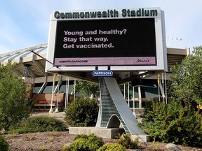 An advertisement promoting COVID-19 vaccinations is visible on a digital billboard outside Commonwealth Stadium, in Edmonton on Monday, Aug. 30, 2021. The Edmonton Elks are requiring fans attending games to show proof of vaccination or a negative COVID-19 test as of Oct. 15. Photo by David Bloom / Postmedia.