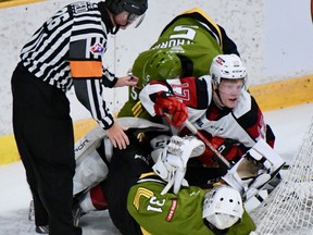 Referee Sean Reid oversees a first-period entanglement involving North Bay Battalion goaltender Dom DiVincentiis, teammate Tnias Mathurin and Brady Stonehouse of the Ottawa 67's in Ontario Hockey League exhibition action Friday night.
Sean Ryan Photo