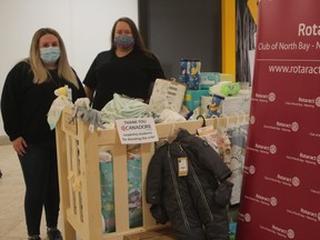 Emily Ryan, left, and Valerie Edmonds of the Rotaract Club of North Bay-Nipissing show off some of the donations to the club's Fill the Crib event, Saturday, at Northgate Shopping Centre. Donations went to support the Trinity Infant Food Shelf and the Newborn Intensive Care Unit at the North Bay Regional Health Centre. PJ Wilson/The Nugget