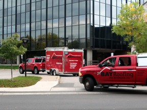 Bay Roofing employees drive through the parking lot at North Bay City Hall during a protest, Monday morning. PJ Wilson/The Nugget