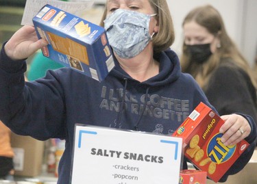 Steph Van Buskirk sorts food during St.Vincent Place's Big Blue Food Drive on Saturday, Sept. 25, 2021 in Sault Ste. Marie, Ont. (BRIAN KELLY/THE SAULT STAR/POSTMEDIA NETWORK)