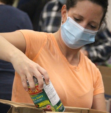 April Love sorts food during St.Vincent Place's Big Blue Food Drive on Saturday, Sept. 25, 2021 in Sault Ste. Marie, Ont. (BRIAN KELLY/THE SAULT STAR/POSTMEDIA NETWORK)