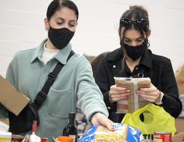 Isabella DiBeradino and Tianna Fera sort food during St.Vincent Place's Big Blue Food Drive on Saturday, Sept. 25, 2021 in Sault Ste. Marie, Ont. (BRIAN KELLY/THE SAULT STAR/POSTMEDIA NETWORK)