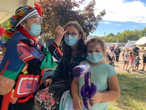 Snippity the clown was busy all afternoon painting faces and making balloon animals. Pictured is Logean Guay and Maddie Haldenby. Hannah MacLeod/Lucknow Sentinel