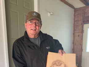 Stephen Mann shows off the portrait that was drawn of his twin brother, Stewart, who passed away as a teen. Mann was recently connected with the portrait after the artist, high-school classmate Janet Cardiff, found it at her mother's home. Hannah MacLeod/Lucknow Sentinel