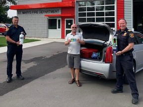 The St. Marys Fire Department will be giving away free fire extinguishers on Saturday as first responders encourage residents to keep one in their vehicles. Pictured is fire Chief Richard Anderson (right), chief fire prevention officer Brian Leverton, and retired paramedic Lorne Culbert. (Contributed)