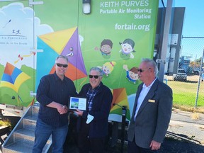 Lamont Mayor Bill Skinner (right) looks on as Fort Air Partnership Chairman Allan Weslet (left) congratulates long-time Board member Keith Purves for having the organization's portable air monitoring station, now located in Lamont, named after him. Photo Supplied by Fort Air Partnership.