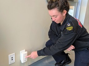 Quinte West Fire Prevention Officer Sarah Scott tests a smoke detector in advance of a fire-safety campaign.