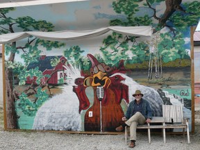 Ron Schmidt in front of his first mural Buck Buck Buck” located on The Venue site in downtown High River.