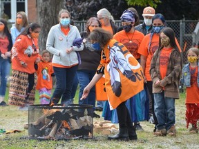 Susan Macdonald of Toronto makes a tobacco offering following a ceremony at the M'Wikwedong Indigenous Friendship Centre marking the National Day for Truth and Reconciliation in Owen Sound, Ont., on Thursday, September 30, 2021.