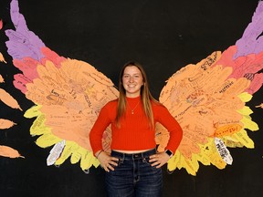A large art installation was the centerpiece of Simcoe Composite School’s celebration of the first annual National Truth and Reconciliation Day on Thursday. Posing with this set of wings – each feather inscribed by students with a personal message of reconciliation – is Charlie Ellis, a member of SCS’s social media club. – Monte Sonnenberg