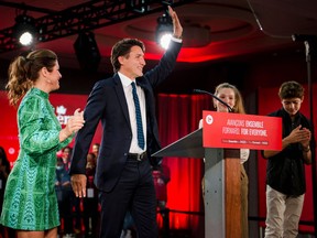 Canadian Prime Minister Justin Trudeau, flanked by wife Sophie Gregoire-Trudeau and children Ella-Grace and Xavier, waves as he arrives to deliver his victory speech after general elections at the Queen Elizabeth Hotel in Montreal, Quebec, early on September 21, 2021. Photo by ANDREJ IVANOV/AFP via Getty Images