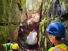 Searchers spent four days in this crevice but found no obvious signs of Lisa Maas's remains. A bag of debris is about to be hauled out in this supplied photo.