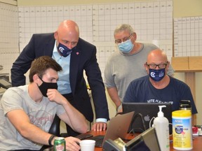 Alex Ruff watches some early election results come in at his campaign office with some of his team members at Heritage Place mall on Monday, September 20, 2021.