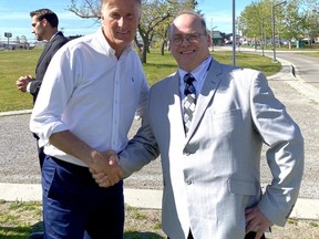 PPC candidate Shawn McLean (right) is pictured with PPC party leader Maxime Bernier (left), while PPC candidate Ryan Dyck speaks with a supporter in the background.