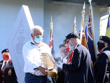 Elder Vince Pawis conducts a smudging ceremony as Royal Canadian Legion Branch 564 hosts a dedication ceremony for its expanded cenotaph, which now includes two granite memorial walls in tribute to deceased veterans who were members of the Lockerby Legion, as well as paver stones dedicated to legionnaires, veterans and their loved ones, in Sudbury, Ontario on Saturday, September 18, 2021. Ben Leeson/The Sudbury Star/Postmedia Network