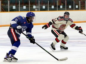 Greater Sudbury Cubs forward Cameron Walker (8) carries the puck while under pressure from Blind River Beavers forward Caleb Minns (64) during first-period NOJHL action at Gerry McCrory Countryside Sports Complex in Sudbury, Ontario on Thursday, September 23, 2021.